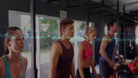 group of five gym members performing exercises in fitness studio, displaying floating data points