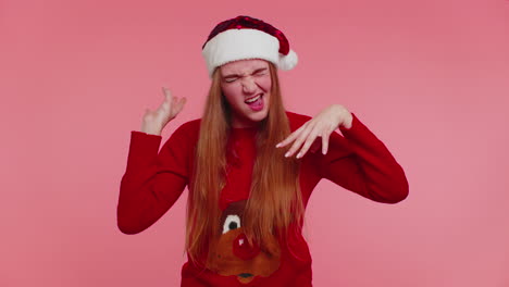 Crazy-girl-in-Christmas-Santa-sweater-hat-demonstrating-tongue-out-fooling-around-making-silly-faces