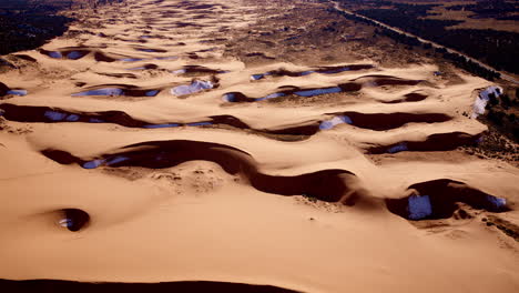 drone footage from above reveals a pastel dream of pink dunes and artistic landforms in southern utah.