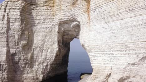 white cliffs with arch overlooking the ocean