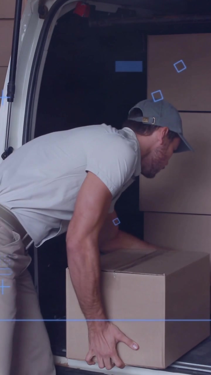 Vertical video: Shifting into van, delivery worker lifting box to load for delivery, smiling