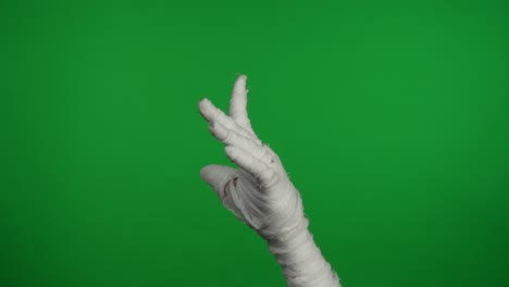 detail green screen isolated chroma key video capturing mummy's hand holding a smartphone and - detail green screen isolated chroma key video capturing mummy’s hand holding a smartphone and pointing at it to encourage joining or buying. mock up, workspace for your promotion clip or advertisement