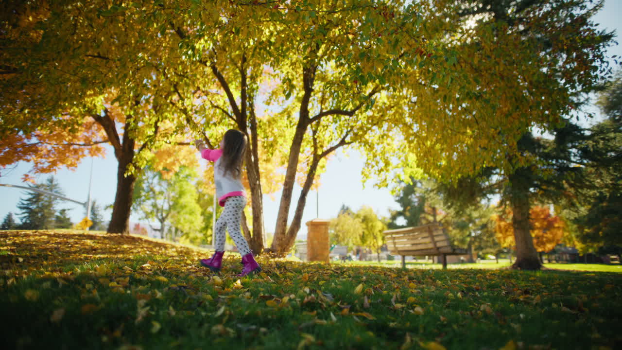 Girl Playing in Autumn Park