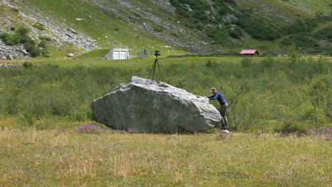 Photographer-on-a-rock-taking-photographs-with-a-tripod