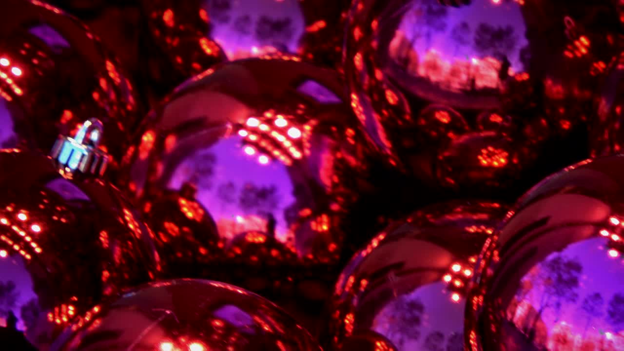 Purple Christmas balls reflecting sky
