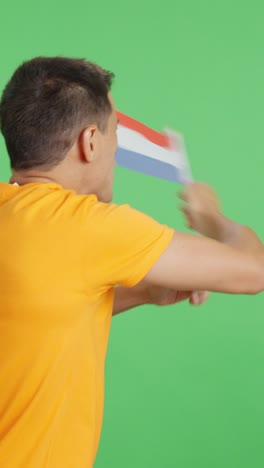 rear view of a man waving a dutch pennant