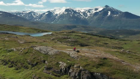 A-couple-of-hikers-has-climbed-a-mountain-peak-Korgfjellet-in-Norway