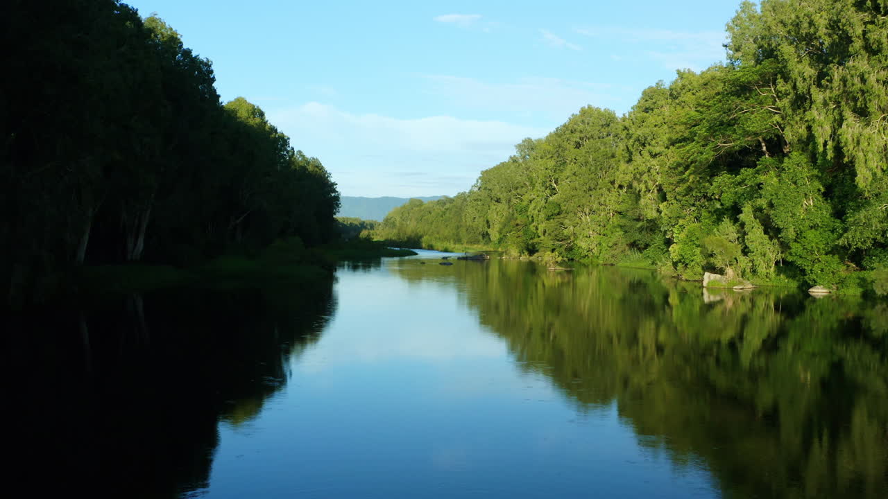 푸른 하늘 반사와 녹색 숲지대, 4k가 있는 여전히 호주 크릭 위에 드론