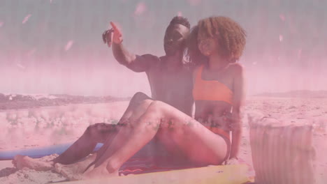 man and woman relaxing on beach towel, using travel app overlay with animated flight icon