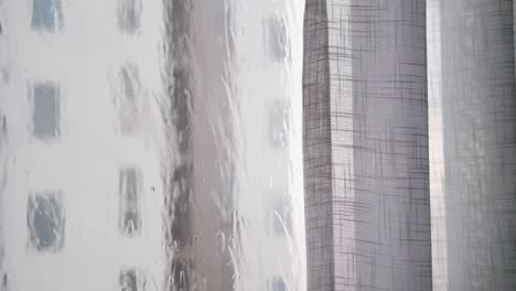 the rain was falling and water splashed on the window. with sheer curtains beside 4k