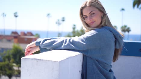 a young pretty blonde girl pose and wear sport jacket