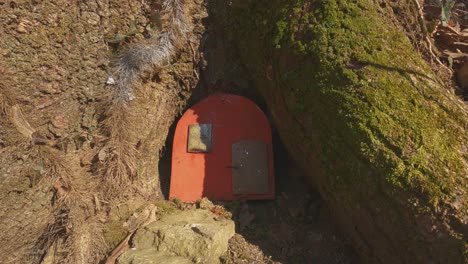 colored elven door and houses in tree trunk at invorio trail of elves in italy