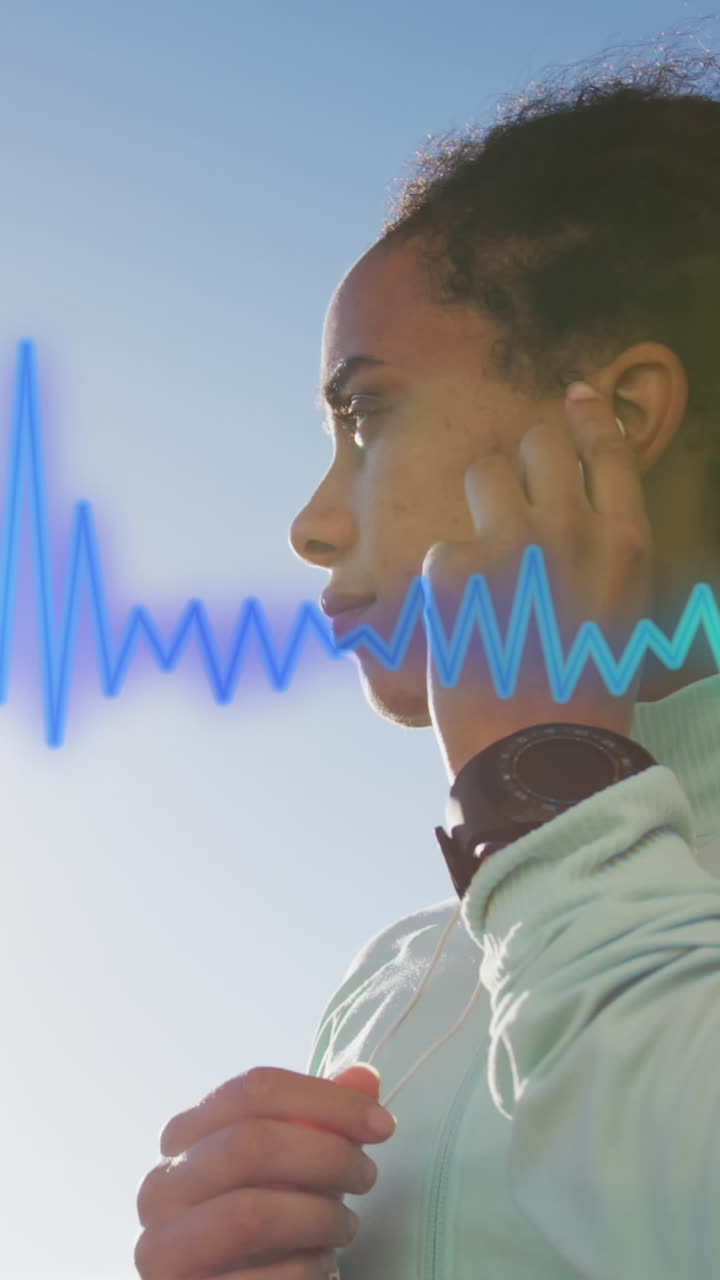 Animation of blue trail over biracial woman wearing earphones
