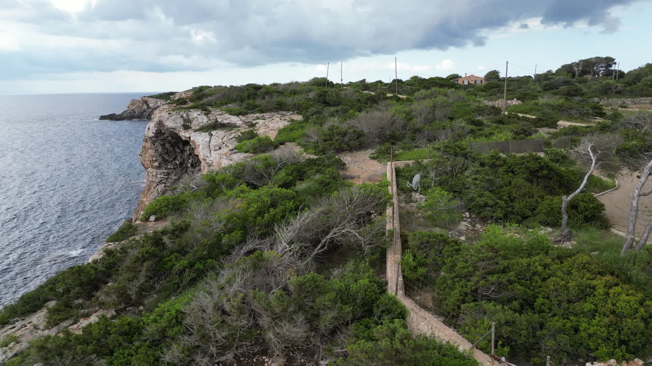 Breathtaking footage of Mallorca's rugged coastline,featuring crystal-clear waters,dramatic cliffs,and sunlit waves crashing against the shore. Captured in stunning 4K from a drone perspective
