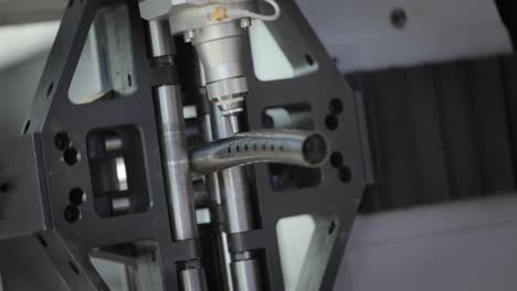 close up of a laser cutting machine cutting a metal tube