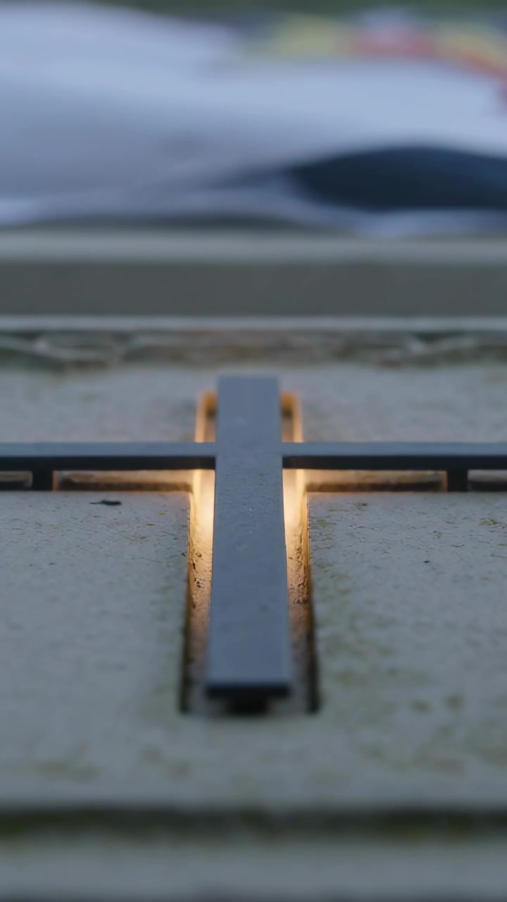 Vertical video: Shifting camera alternating focus on metal cross bar over slab edge, showing grout