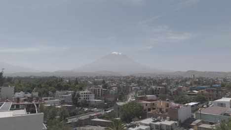 upwards moving drone shot above arequipa peru with view on the mountain near sunset time with clouds in the sky log