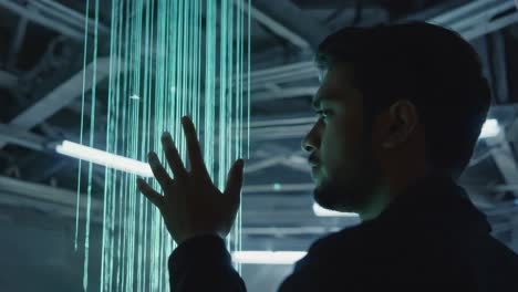man interacting with futuristic glowing vertical lines