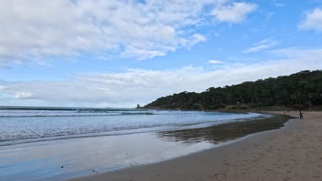 Waves gently crashing on a sandy beach
