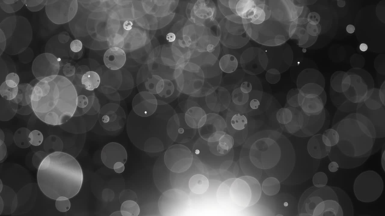 Floating abstract particle bokeh on dark background. Shot on super slow motion camera 1000 fps.