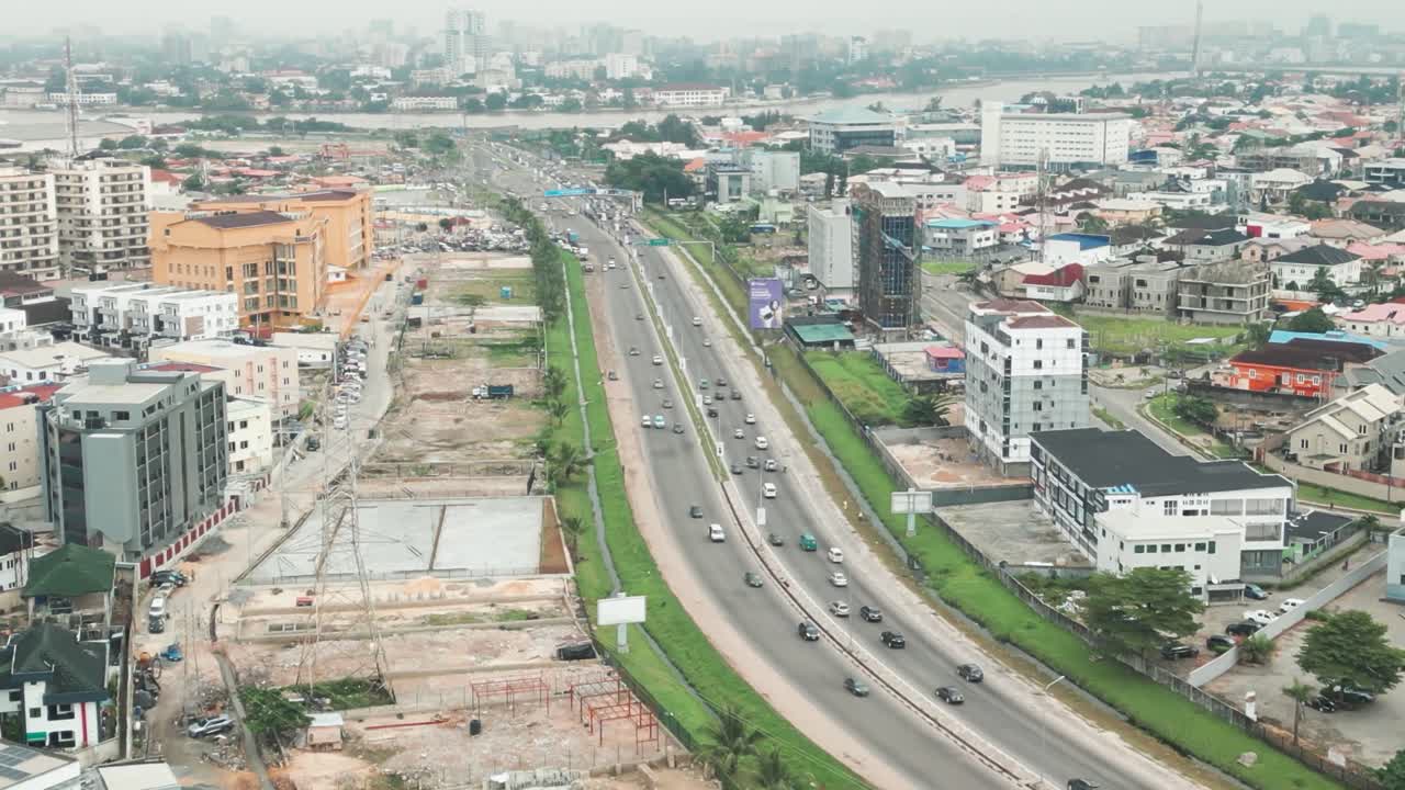 Lagos Nigeria highway traffic flow rush hour transport Africa, aerial drone above urban jungle