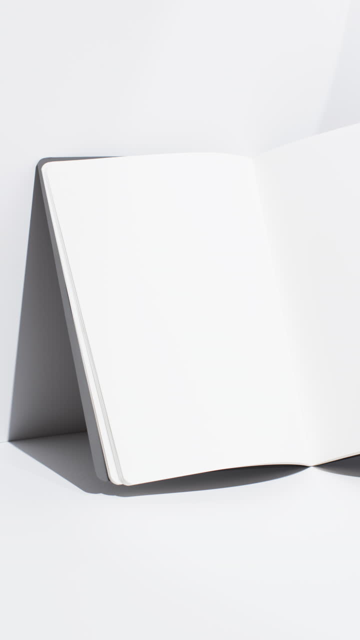Vertical video of book with blank pages and copy space on white background