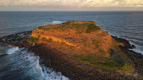 sunlight illuminating at the rocky landscape of cook island during sundown in nsw, australia