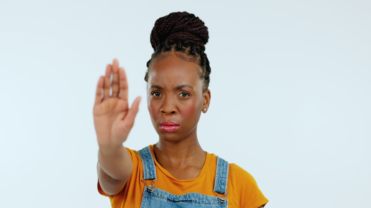 Stop, hand and face of black woman in studio