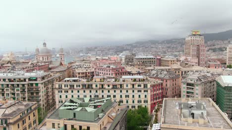 stormy clouds over city of genoa, aerial cinematic rotate left view