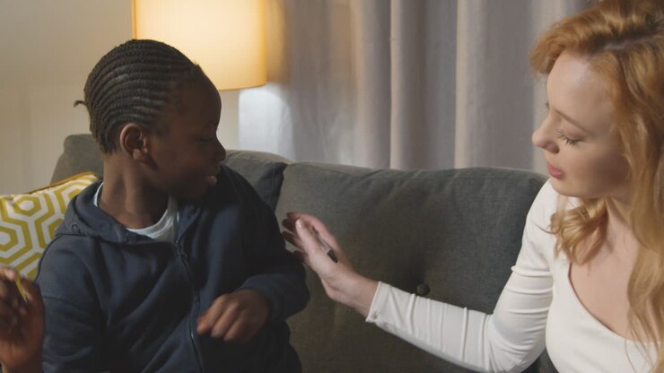 Boy On ASD Spectrum Being Helped Or Assessed By Female Teacher Or Educational Psychologist At Home 2