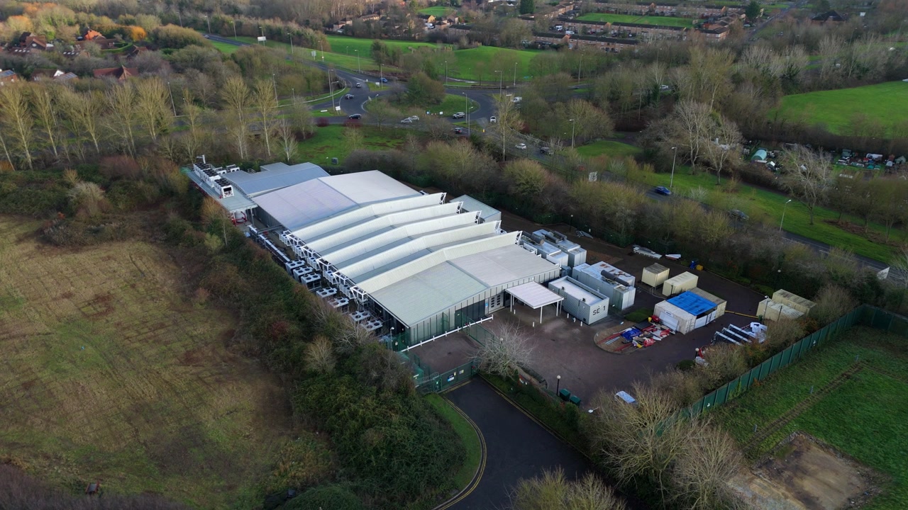 Aerial view of the technological landscape in Milton Keynes featuring an AI-driven data processing center.