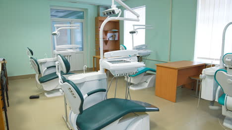 light big study at dentist school for future stomatologists. room with usual furniture and dentist's chairs for students' practice.