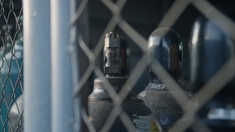 gas cylinder bottles stored in an old rusty warehouse