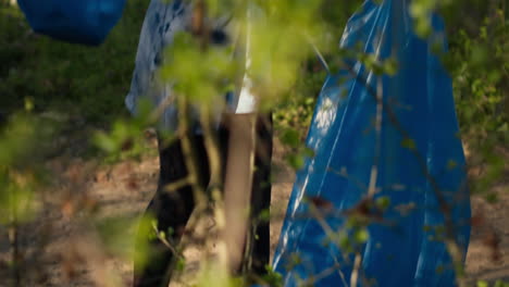 Diverse-group-of-volunteers-picking-up-trash-and-plastic-to-recycle