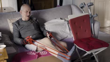 senior man exercising with resistance band at home