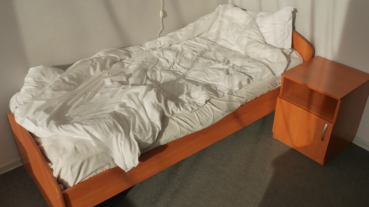 밝은 빛 아래에서 만들어지지 않은 침대.