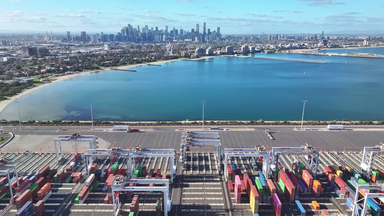 Aerial view of Melbourne container terminal with city skyline and bay in the background