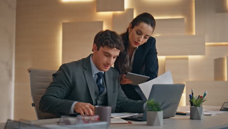 project managers discussing office papers closeup. colleagues talking computer