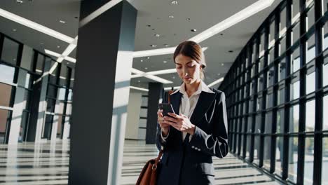 businesswoman using smartphone in modern office