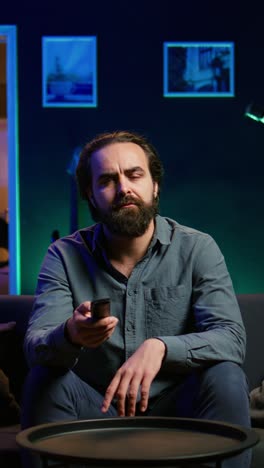 vertical video perplexed man watching unconvincing team performance sports match on tv
