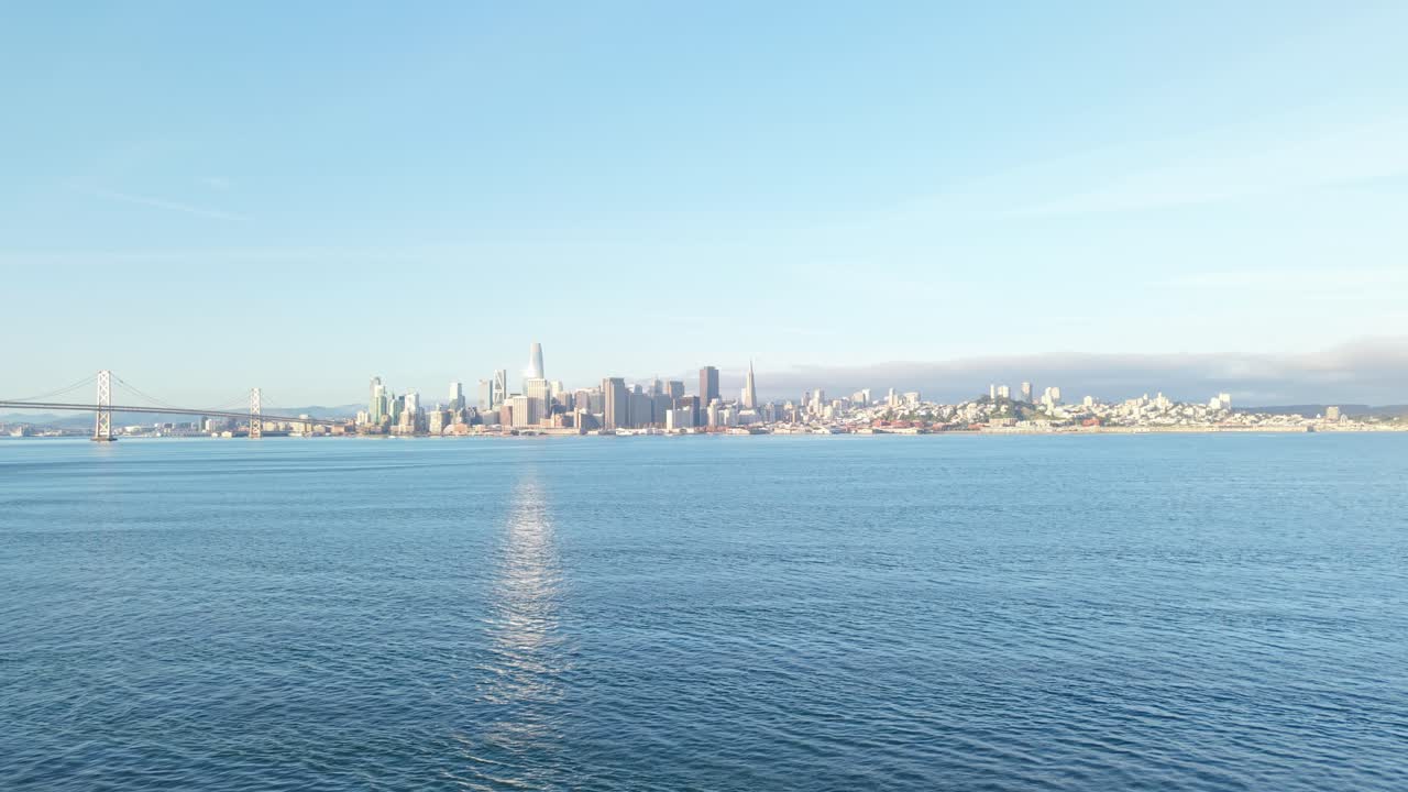 Coastal wind stirs the water below while sunlight plays across rooftops in this structured view of San Francisco’s Embarcadero.