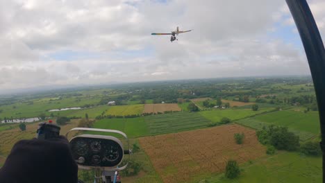 pov of ultralight plane gliding across down to the ricefield