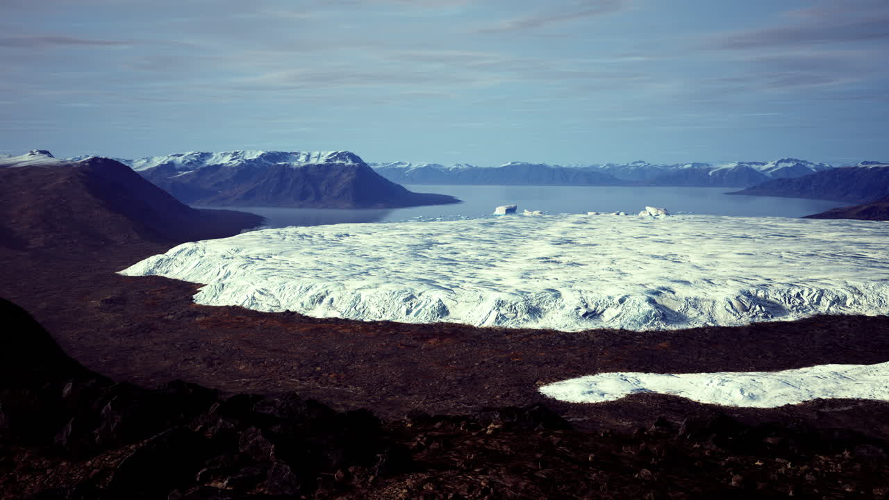 Expansive glacier landscape in a remote mountainous region under clear skies