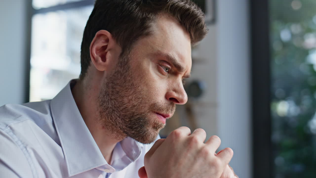 Portrait businessman planning strategies in office. Serious executive pondering