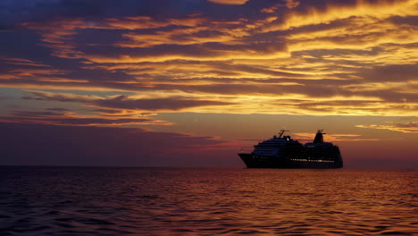 cruise ship on the ocean at sunset