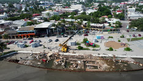 Dismantling-an-old-tanker-with-a-crane-next-to-a-river