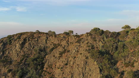 aerial of mountain range, treetops, in outback australia flyover with drone closer