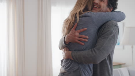 happy-couple-hugging-excited-moving-into-house-new-home-owners-smiling-enjoying-successful-move-milestone-achievement