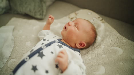 newborn baby crying on blanket close-up