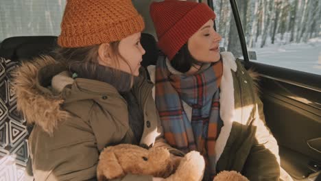 girl and woman traveling by car in winter